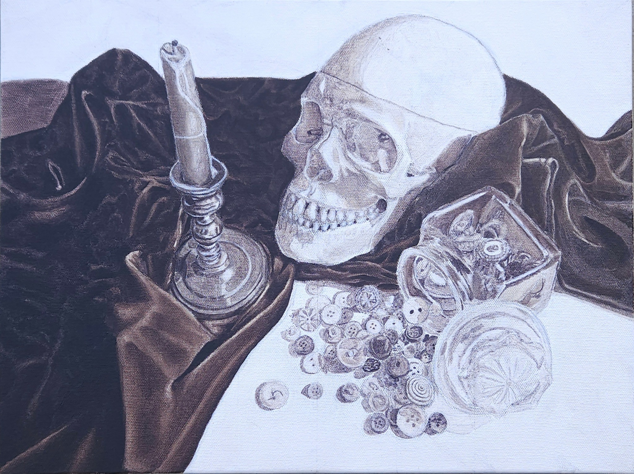 Skull, candle holder, and spilled coins on dark fabric surface.
