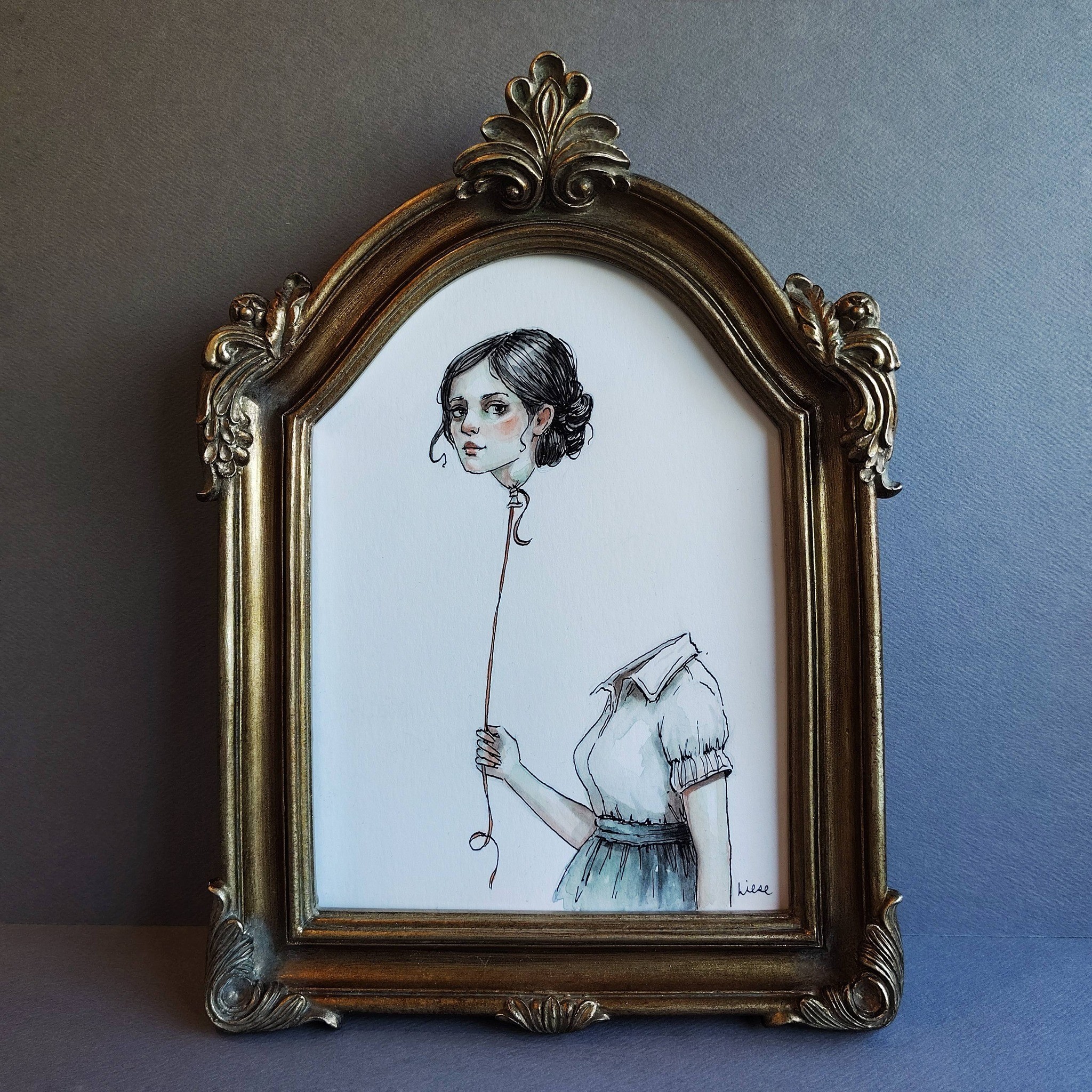 A framed illustration of a girl holding a balloon string, with her face and upper body visible, in a decorative gold frame.