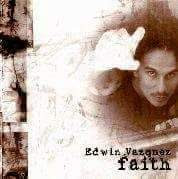 Person with dark hair and a serious expression, reaching out with a hand, in a textured environment, text reads 'Edwin Vazquez fault'.