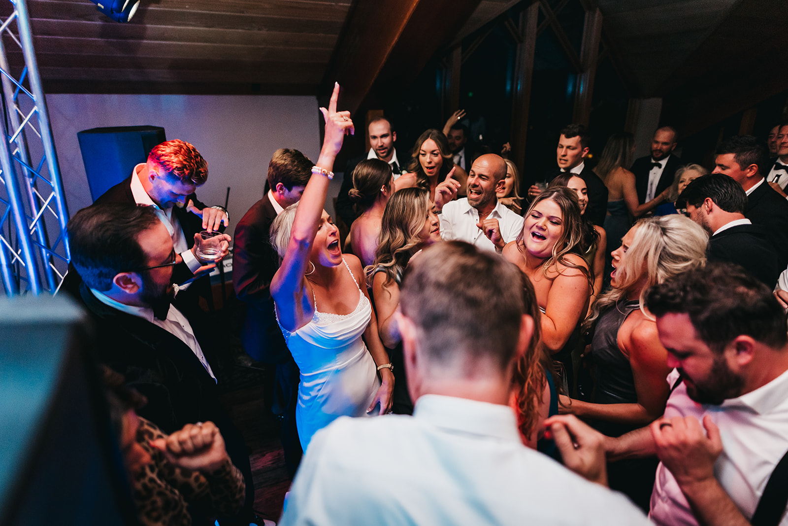 Group of people dancing and celebrating at a party, smiling and enjoying the moment.