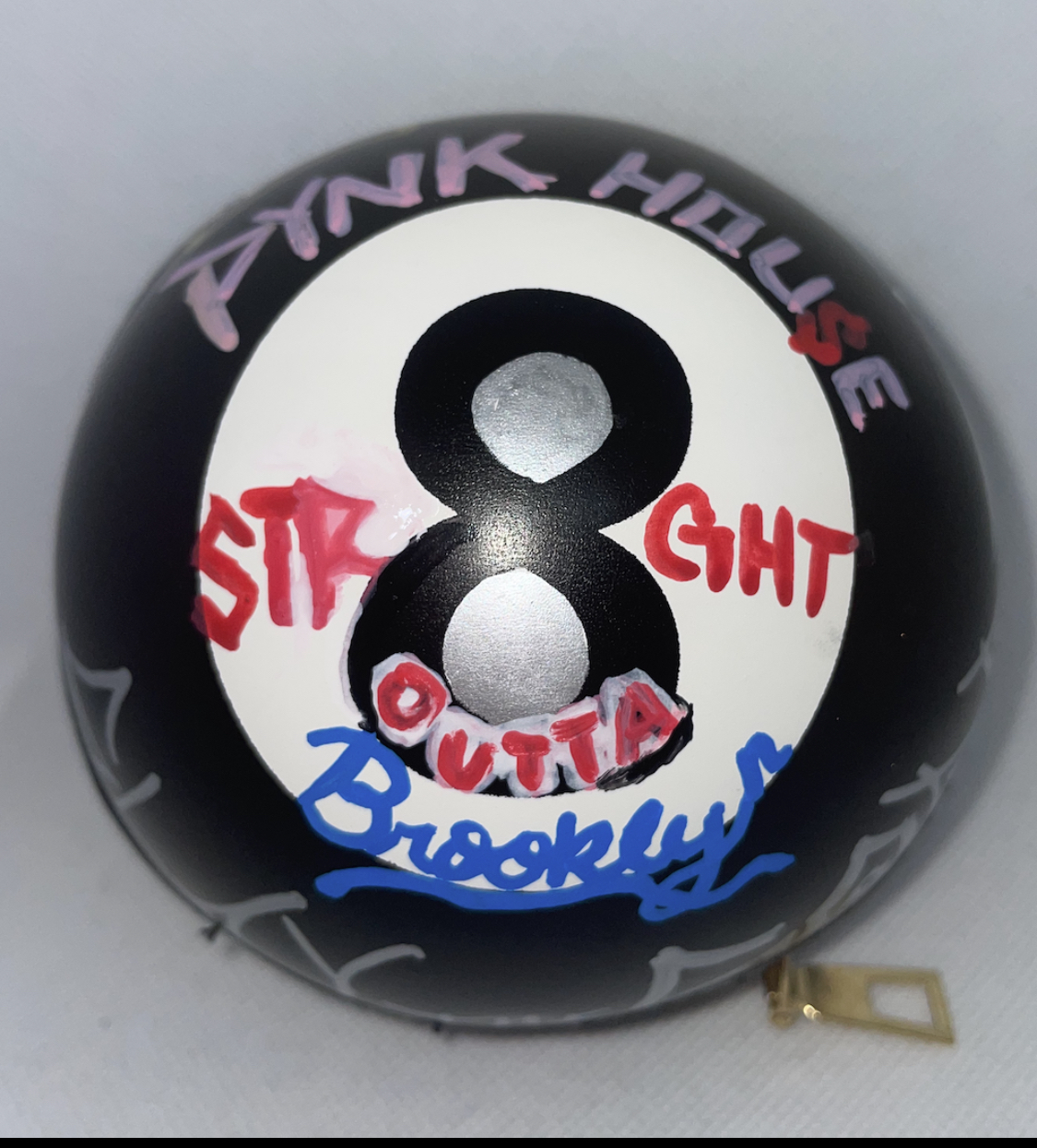 Black pool ball with handwritten colorful text and the number 8 in the center.