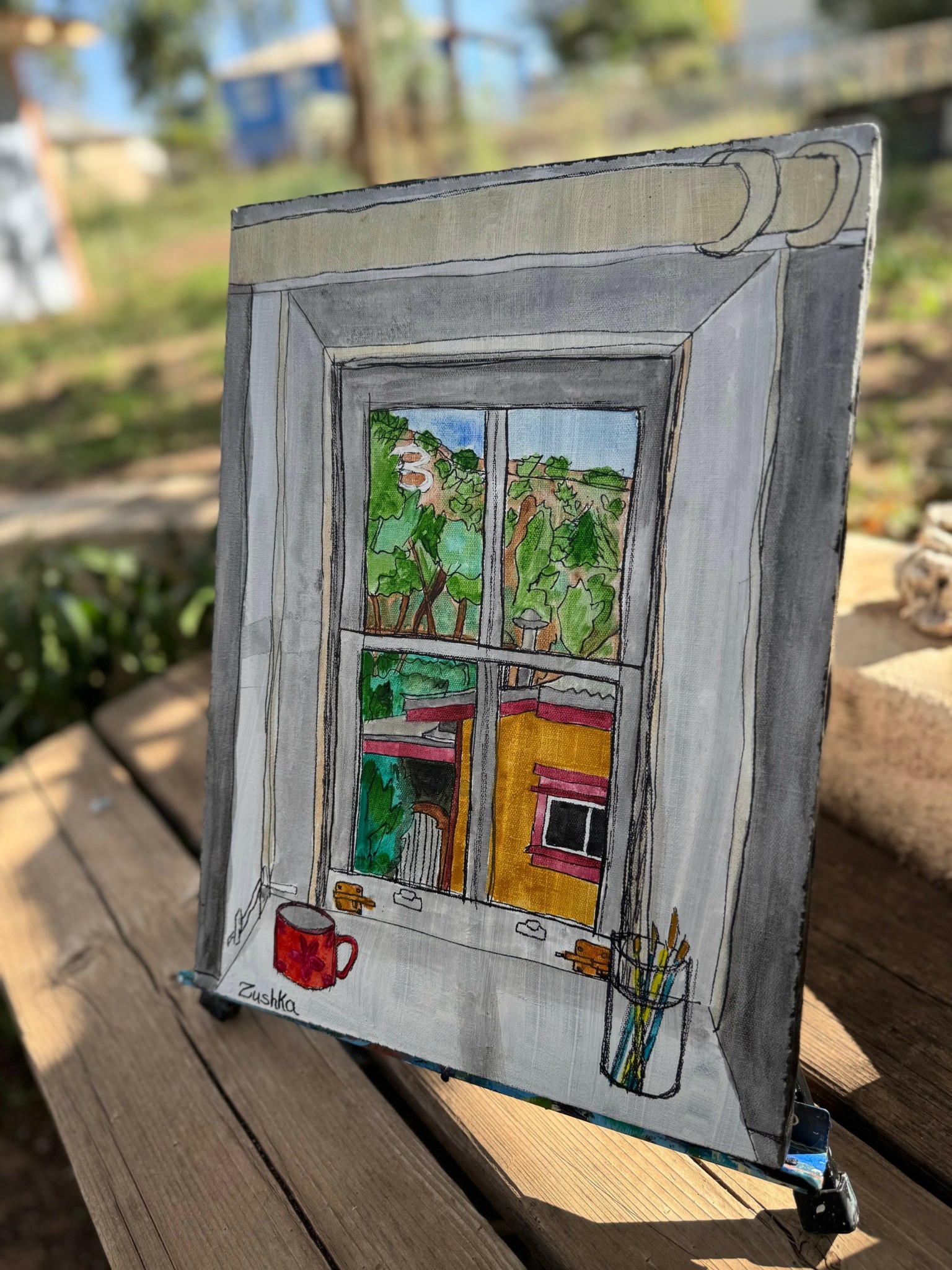 Painting of a window with a view of trees and a house, with a red cup and pencils on the windowsill.