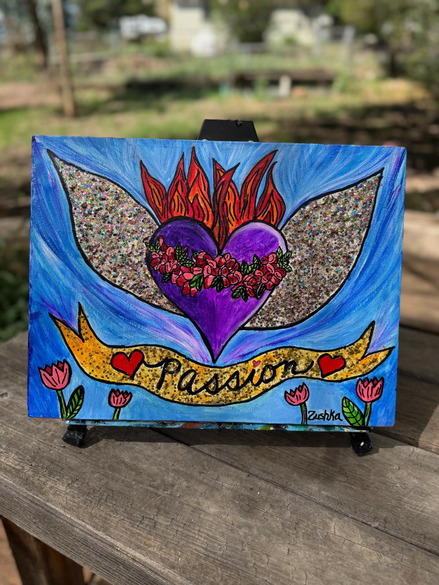 Colorful painting of a heart with flames, surrounded by flowers, with a banner reading 'Passion' on a blue background.