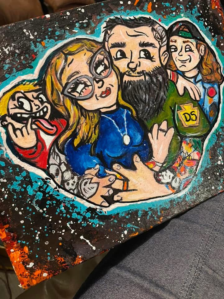 Colorful caricature of four people with exaggerated features, surrounded by splashes of paint, on a dark background.
