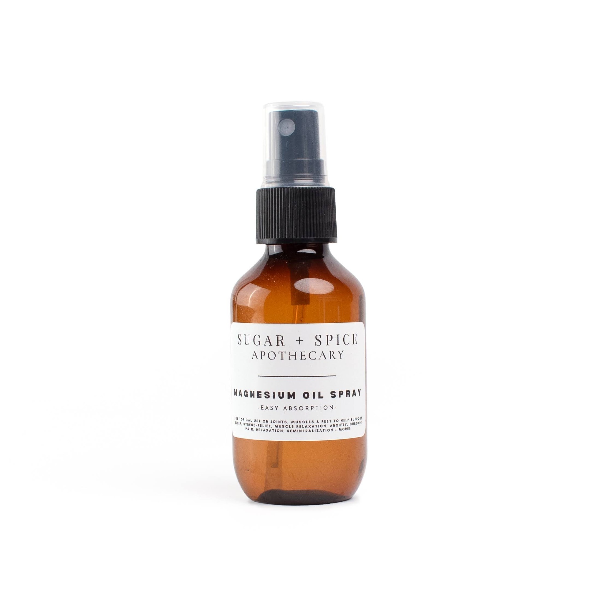 Amber glass spray bottle with a black spray nozzle and a white label, labeled 'Sugar + Spice Apothecary' and 'Kumquat Oil Spray'.