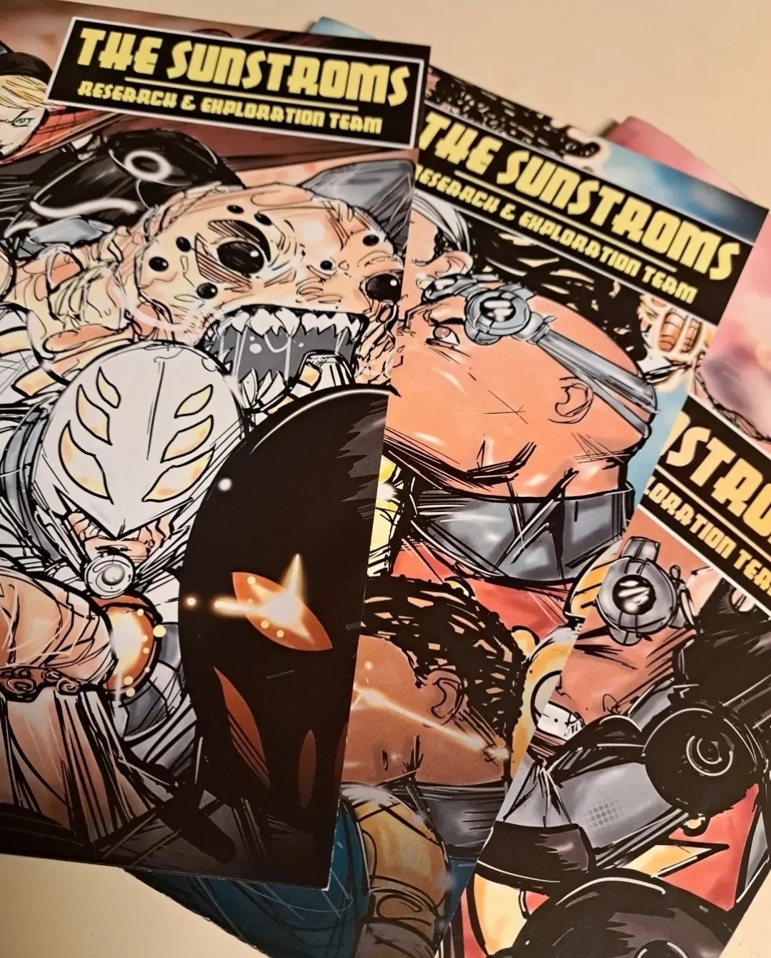 Two comic book covers titled 'The Sunstoms' featuring characters with futuristic armor and weapons, one with a leopard face and the other with a muscular build.