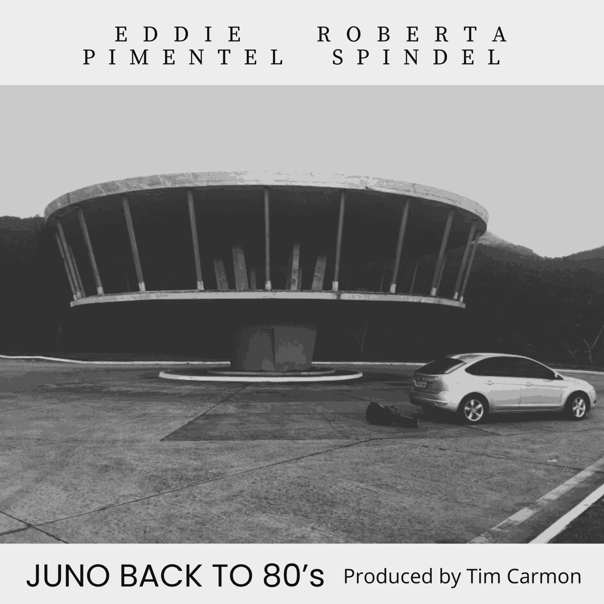 Black and white photo of a modern circular building with a car parked in front, and text at the top and bottom.