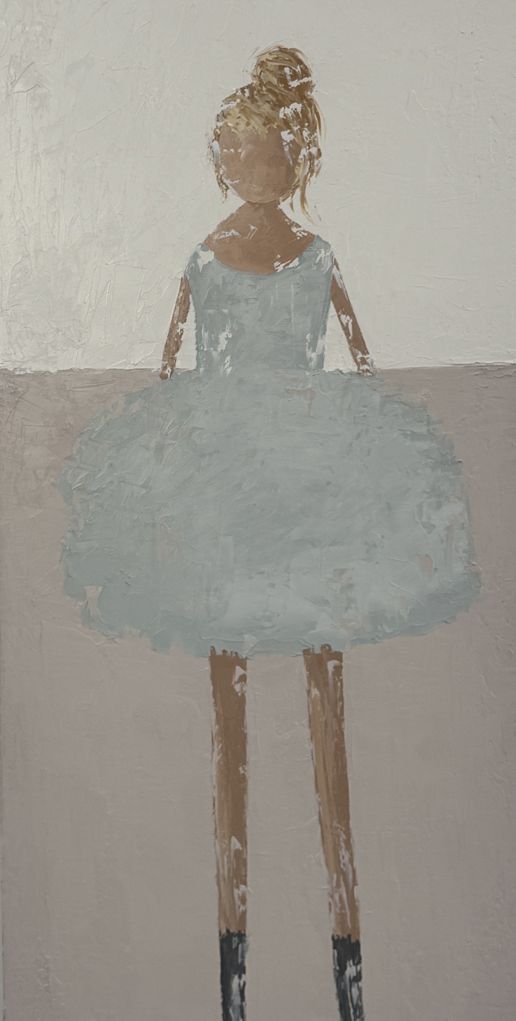 A girl with a bun hairstyle wearing a light blue dress and tutu, standing against a plain background.