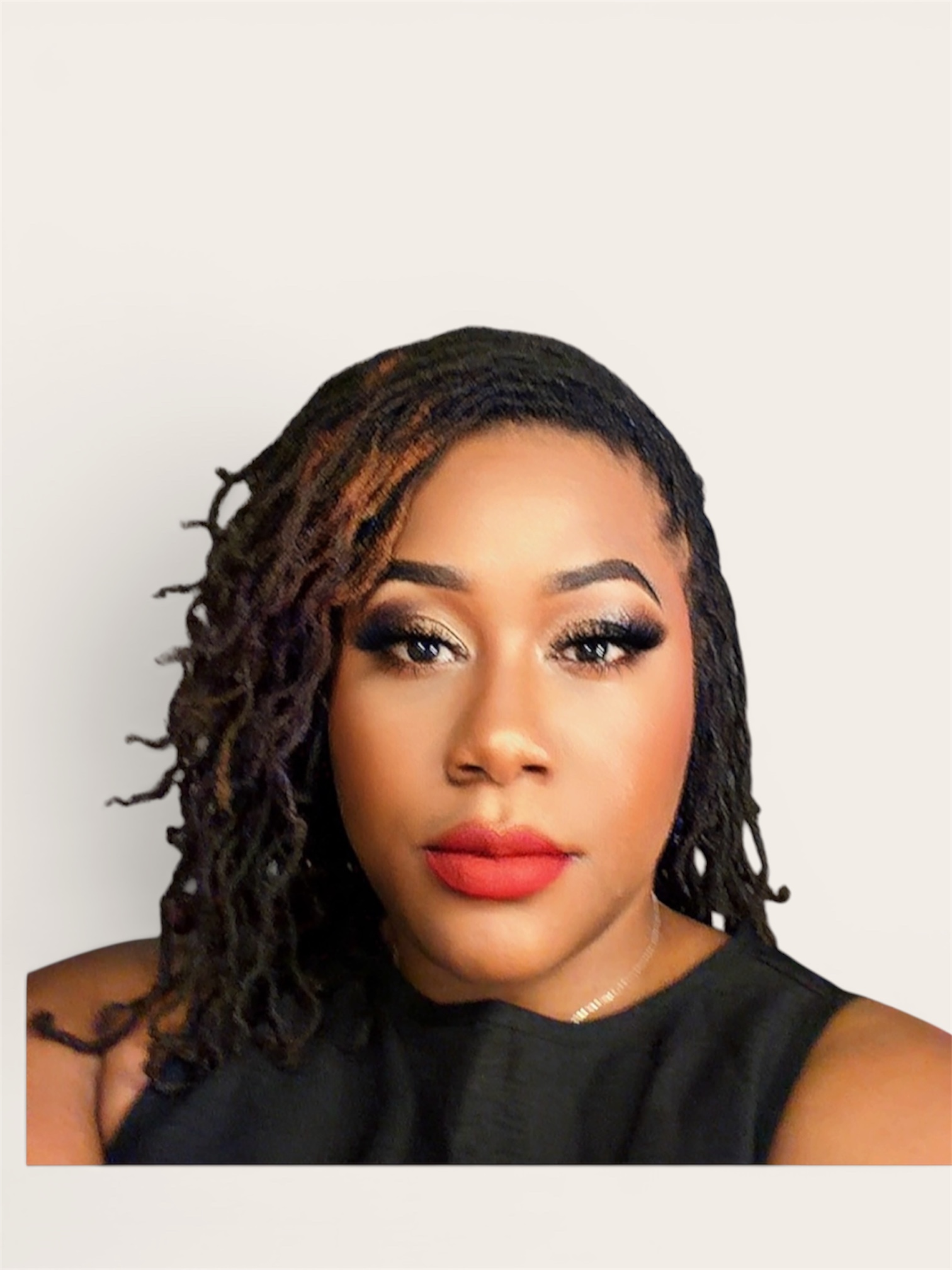 Portrait of a woman with styled dreadlocks, makeup, and a black top, looking directly at the camera.