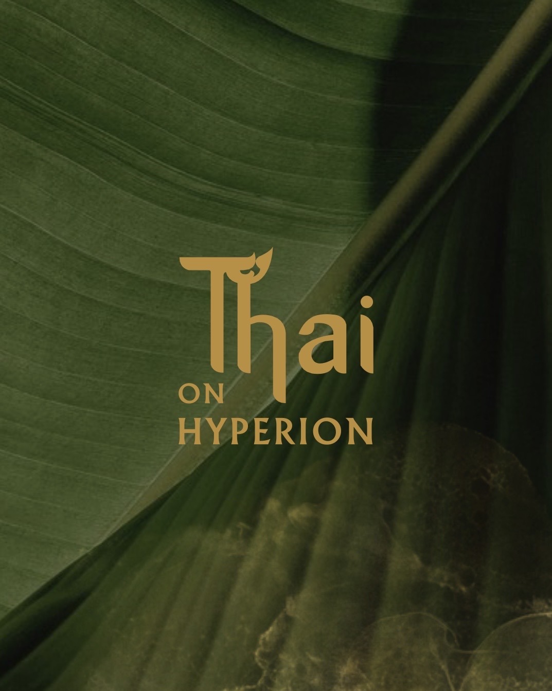 Close-up of green leaves with text 'Thai on Hyperion' in the center.