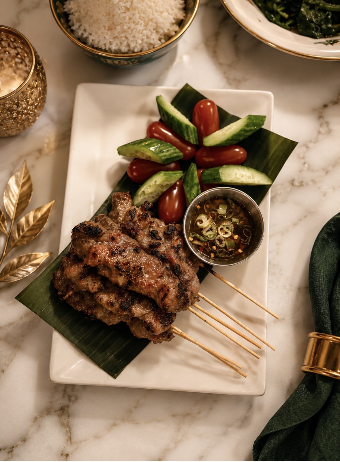 Skewered grilled meat with cherry tomatoes and cucumber slices on a white plate, garnished with green leaves, on a marble surface.