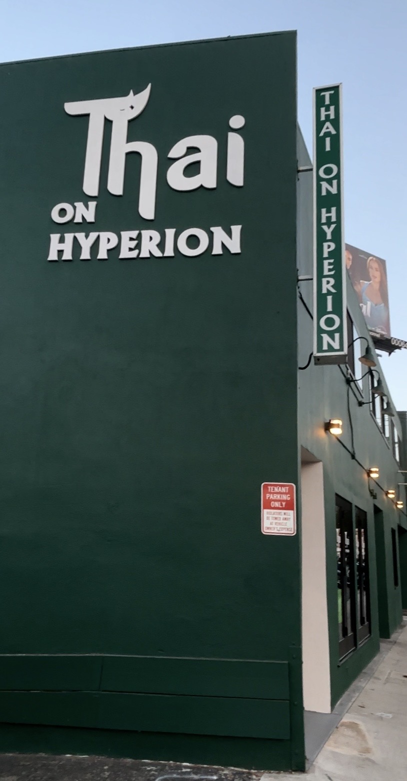Green building with sign reading 'Thai on Hyperion' and vertical sign 'Hanoi Hyperion'.