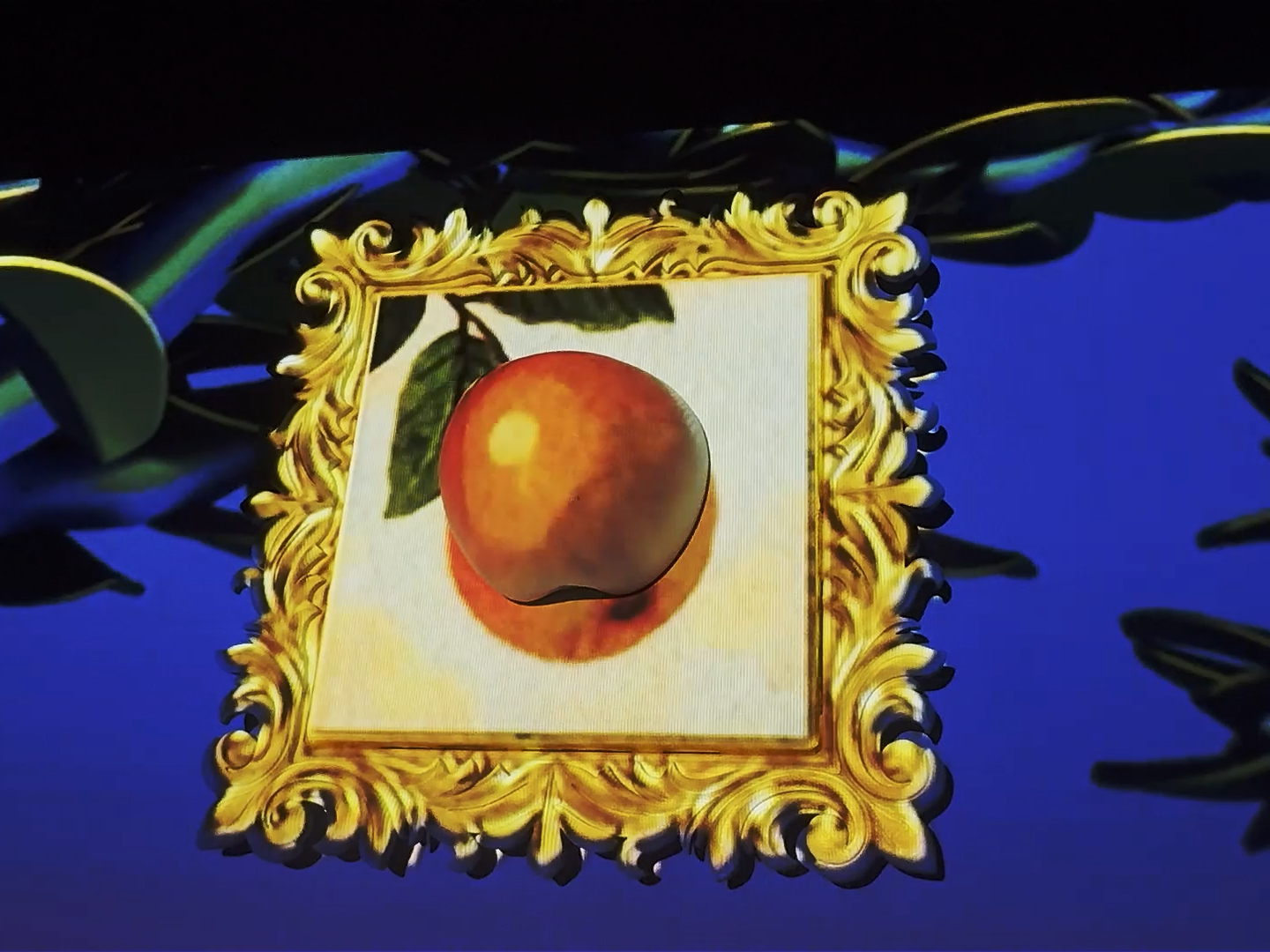 A framed image of an orange fruit with a leaf, surrounded by a decorative gold border.