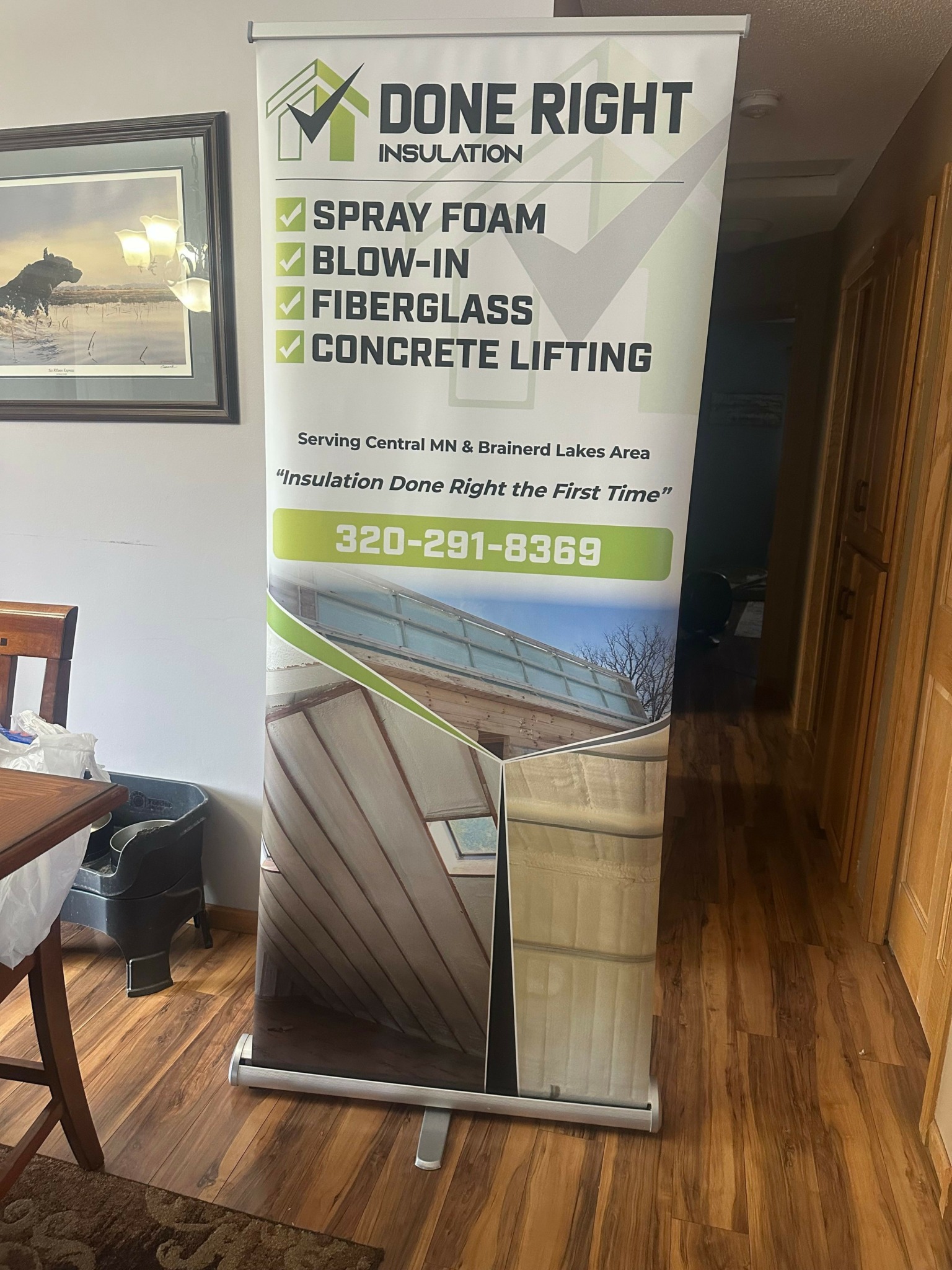 Vertical banner with text and a boat image, promoting concrete lifting services, placed indoors on a wooden floor.