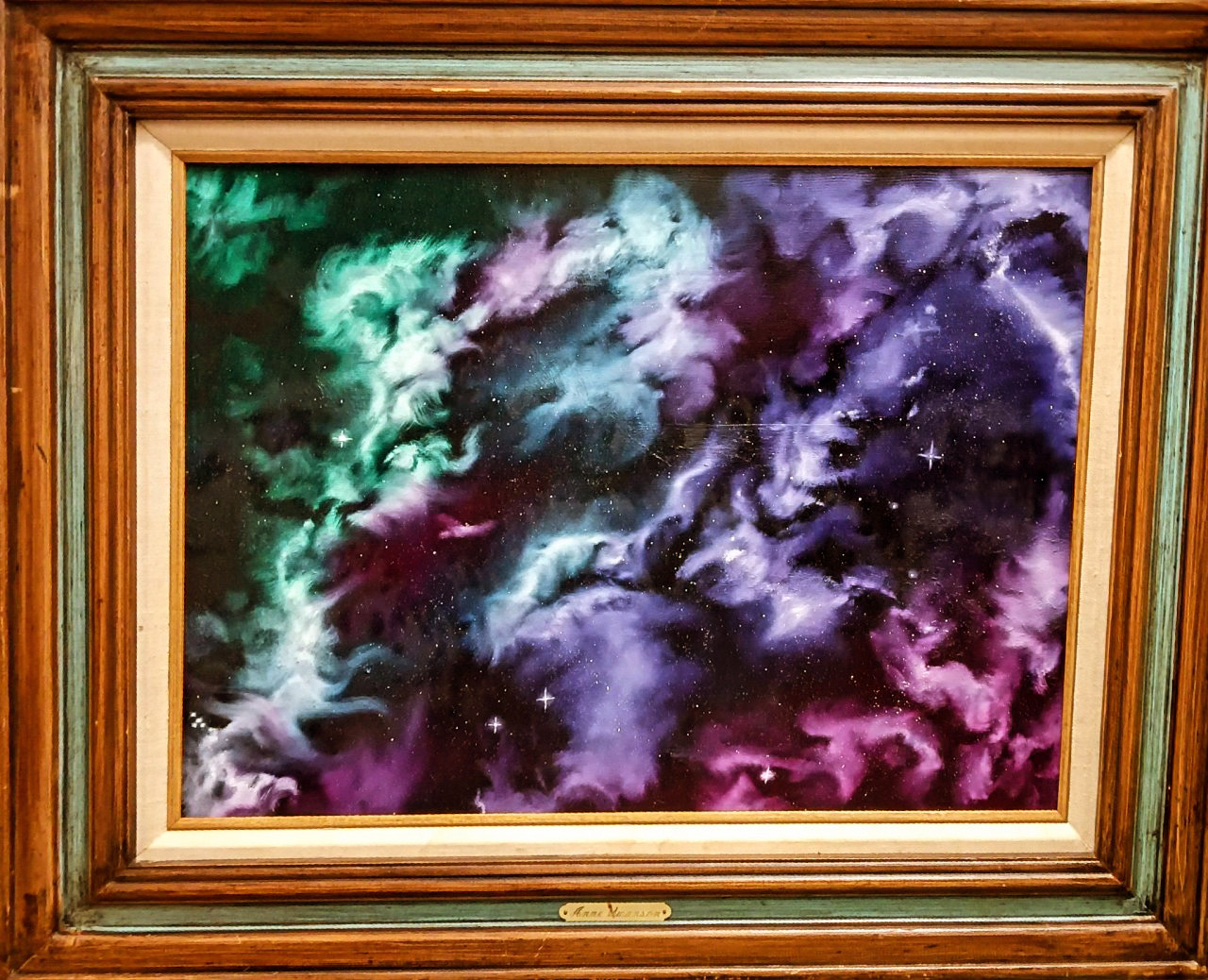 Abstract galaxy scene with colorful clouds and stars, featuring green, purple, pink, and blue hues.