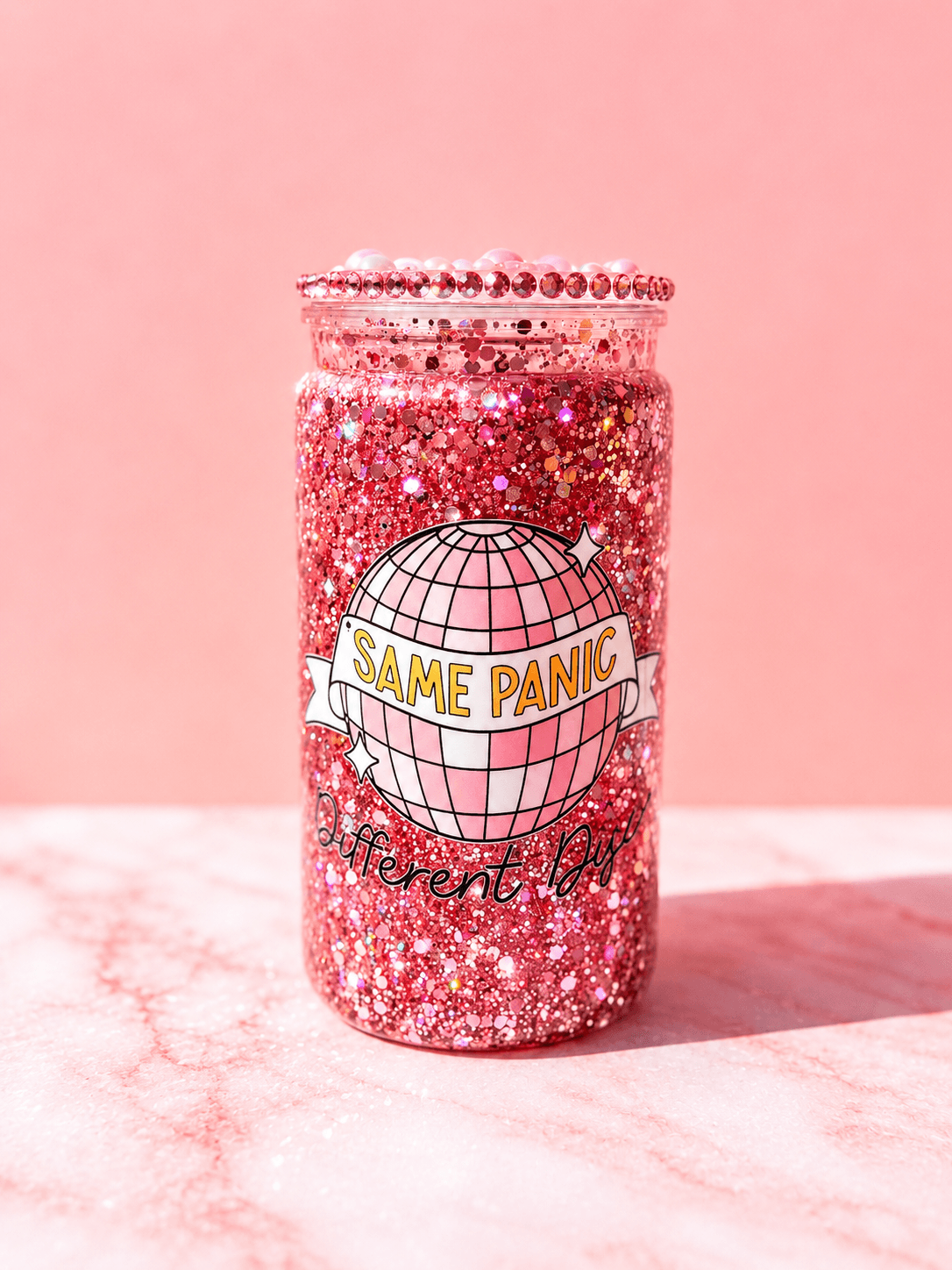 Pink glitter jar with a label reading 