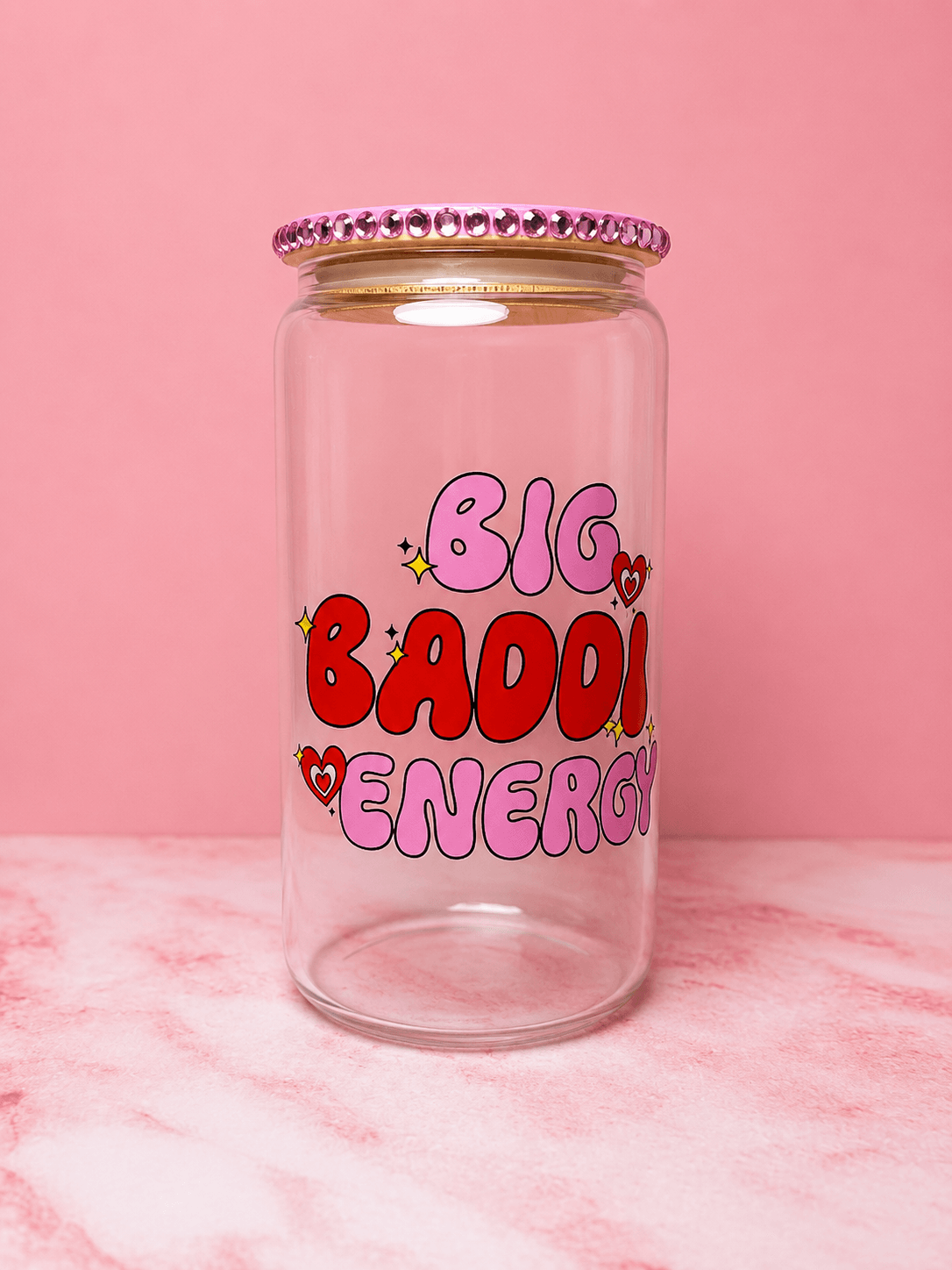 Clear jar with pink, red, and purple text and hearts, on pink background, with a pink beaded lid.