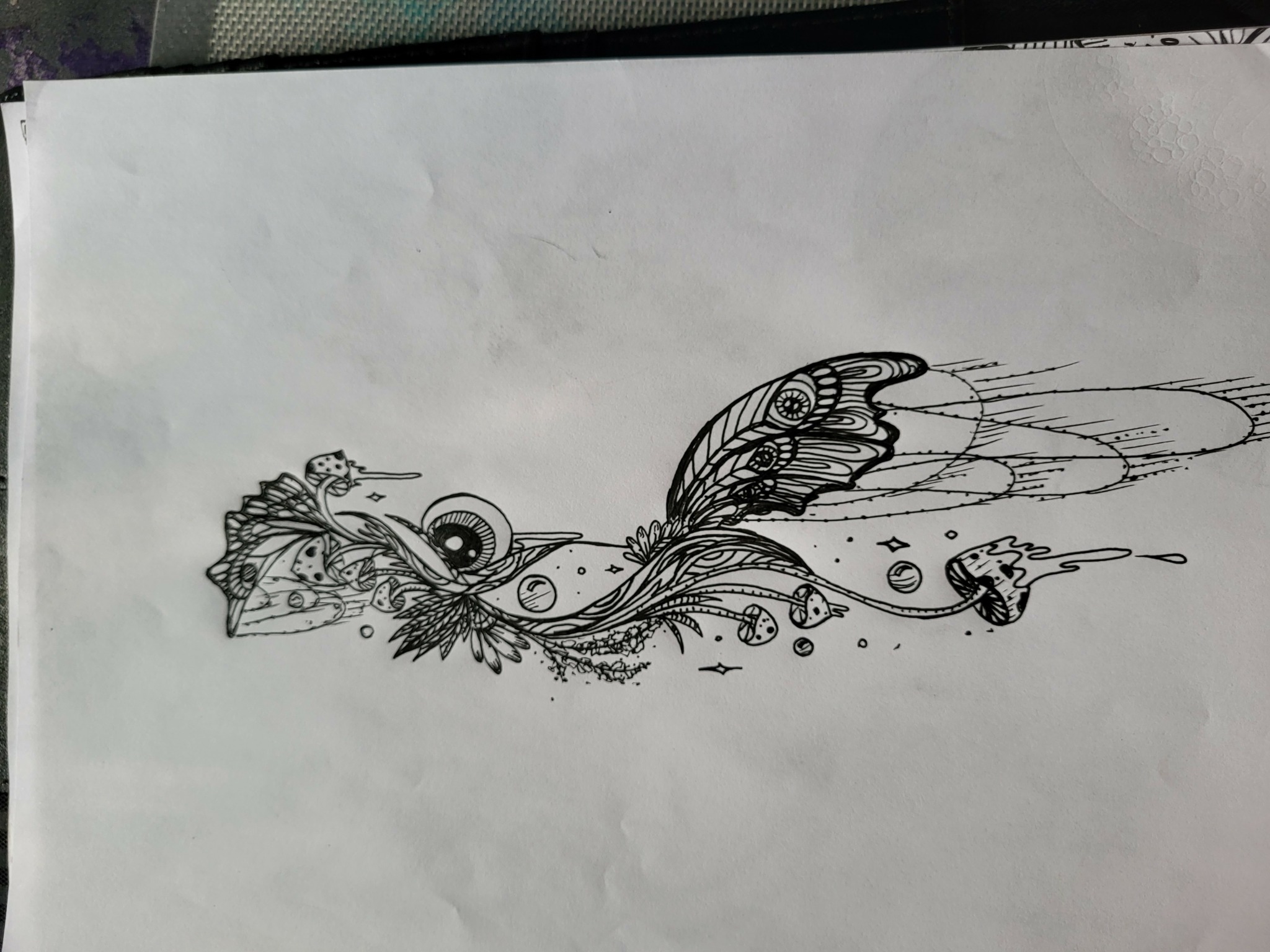 Detailed black and white abstract drawing of a creature with large eye, wings, and flowing lines, on white paper.