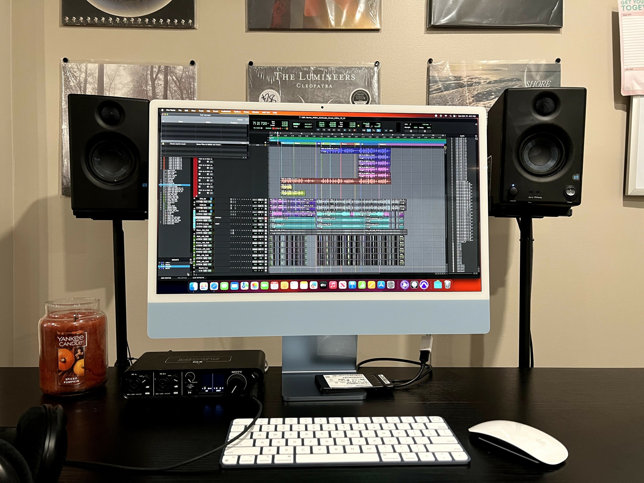 Computer monitor displaying music production software, with speakers on each side, on a desk with a keyboard and mouse.
