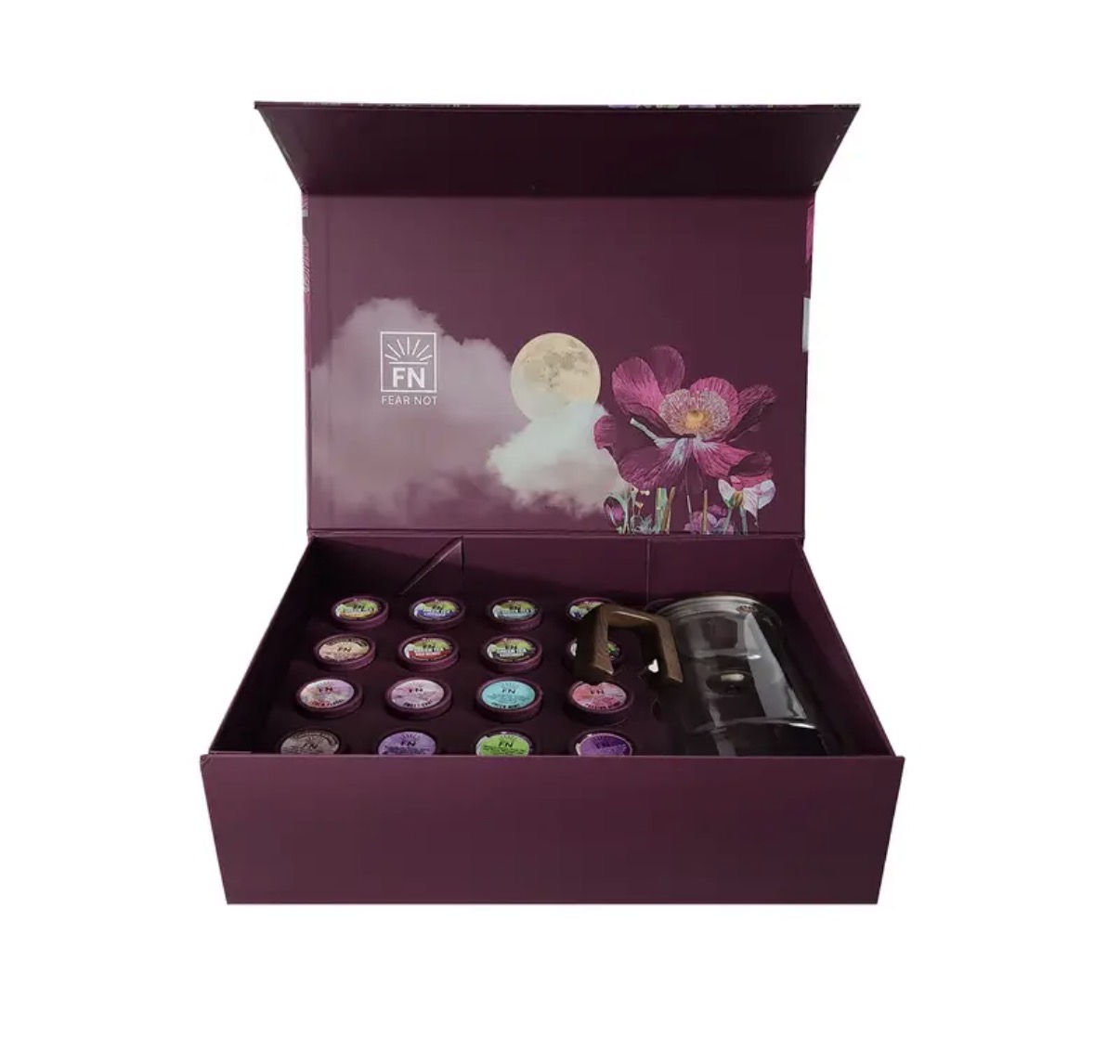 Open box with colorful essential oils and a diffuser inside, purple packaging with moon and flower design, and moon illustration.