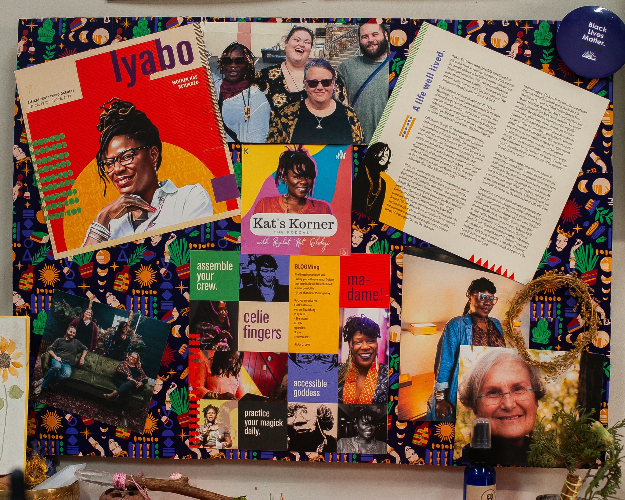 Collection of colorful magazines, photos, and papers on a decorated surface with a person in a photo frame.
