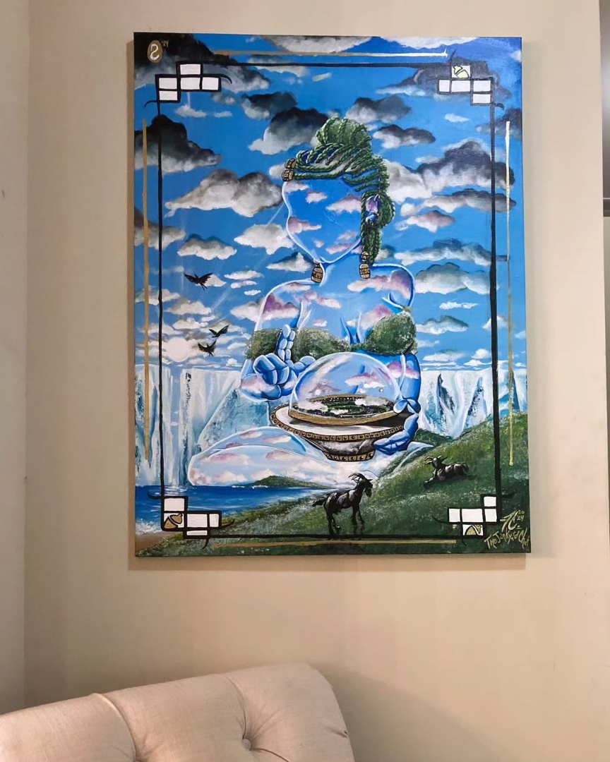 Colorful surreal painting with a sky, clouds, a dinosaur, and various objects, framed and hanging on a wall above a sofa.