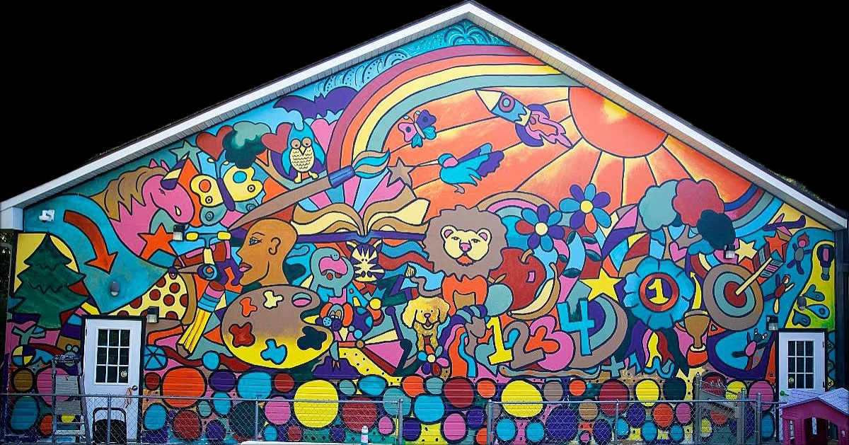 Colorful mural with animals, rainbow, sun, and abstract shapes on a wall.