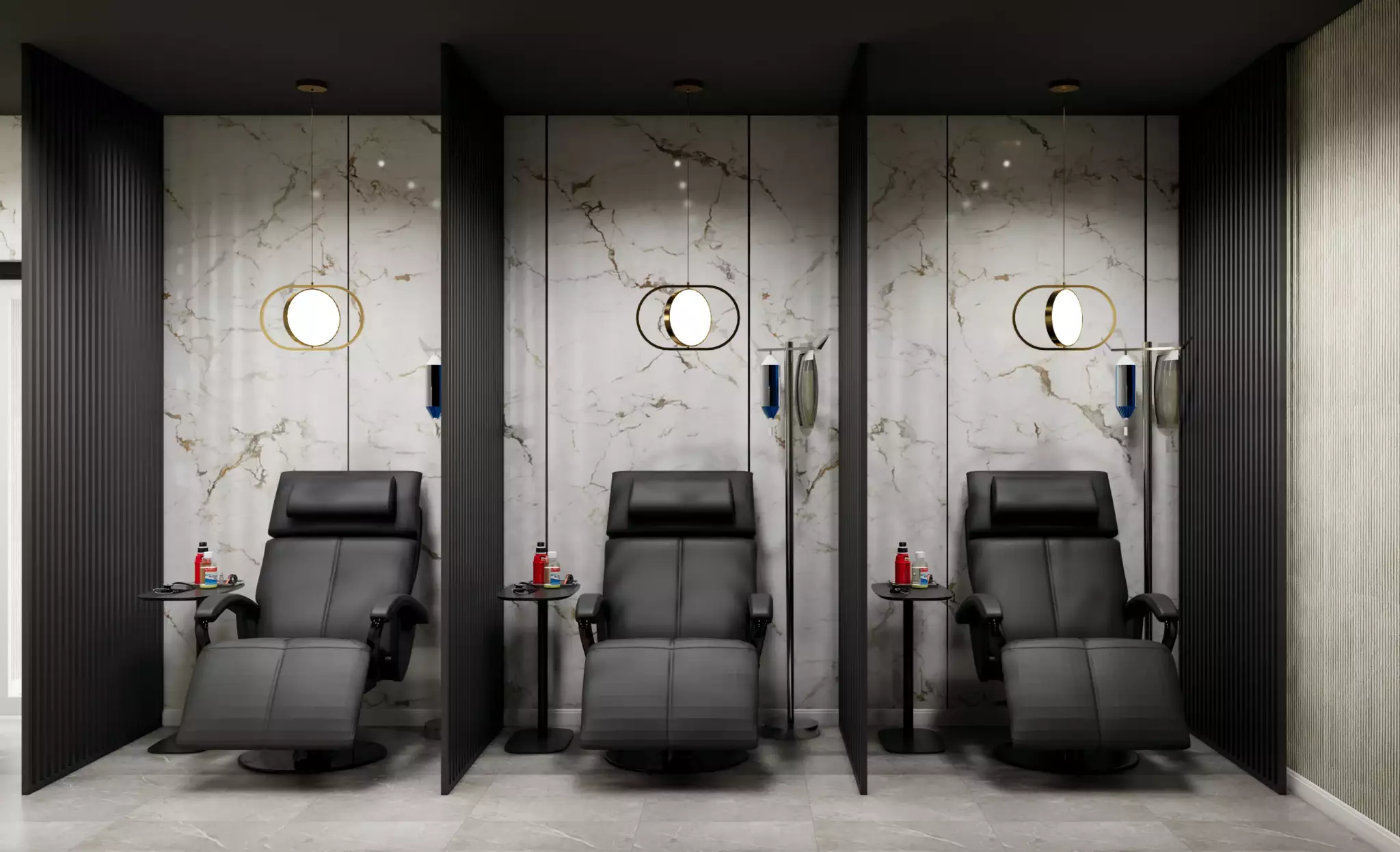 Three reclining chairs separated by black partitions in a modern room with marble walls and circular wall lights.