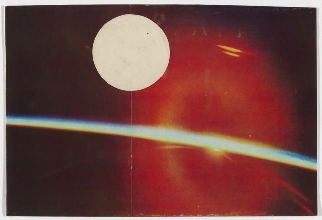 A large white circle, possibly the moon, against a dark sky with a bright horizontal streak and two small glowing objects.