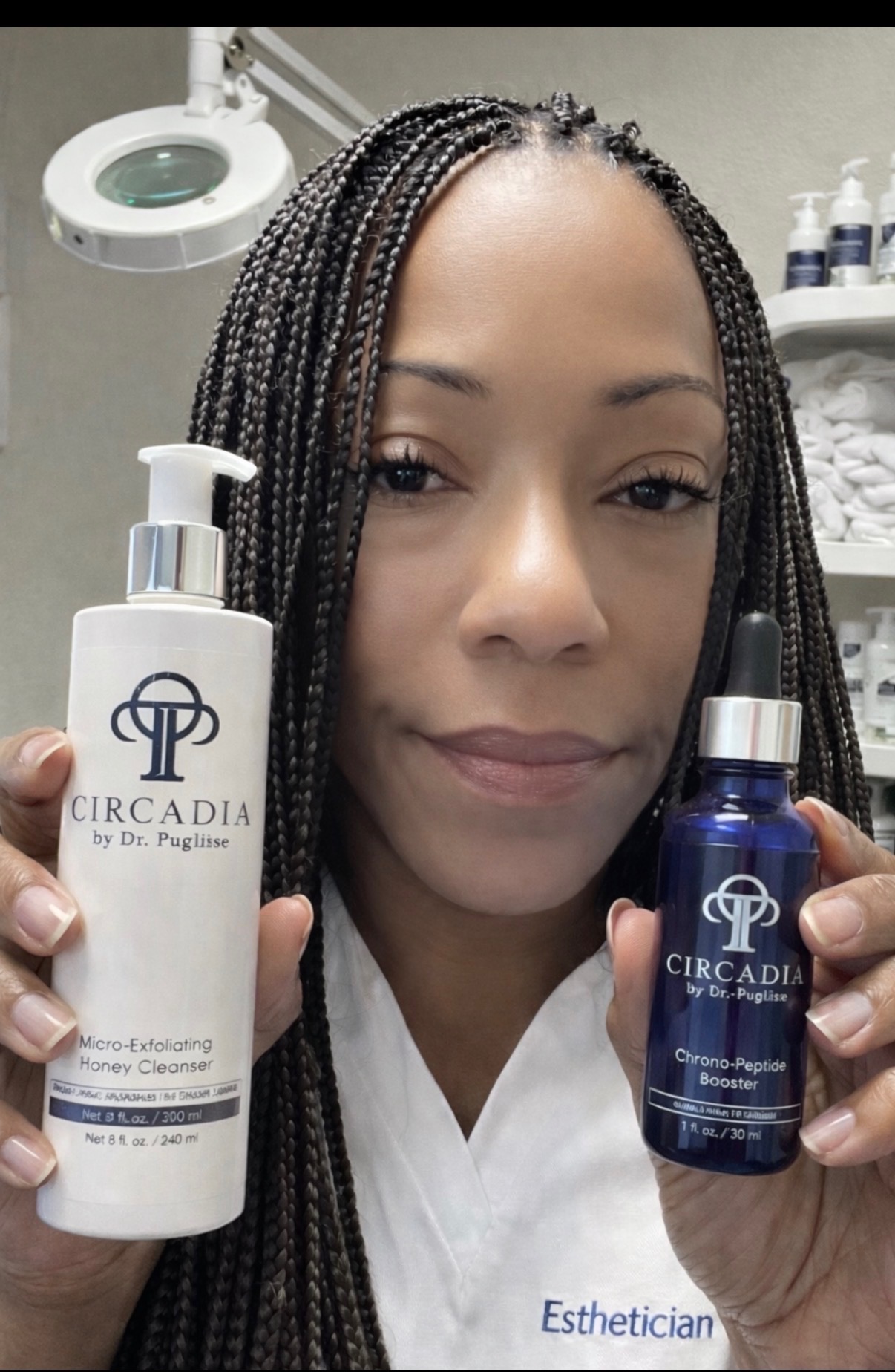 Woman holding skincare products, one labeled 'Circadia' and the other with a dropper, in a clinical setting.