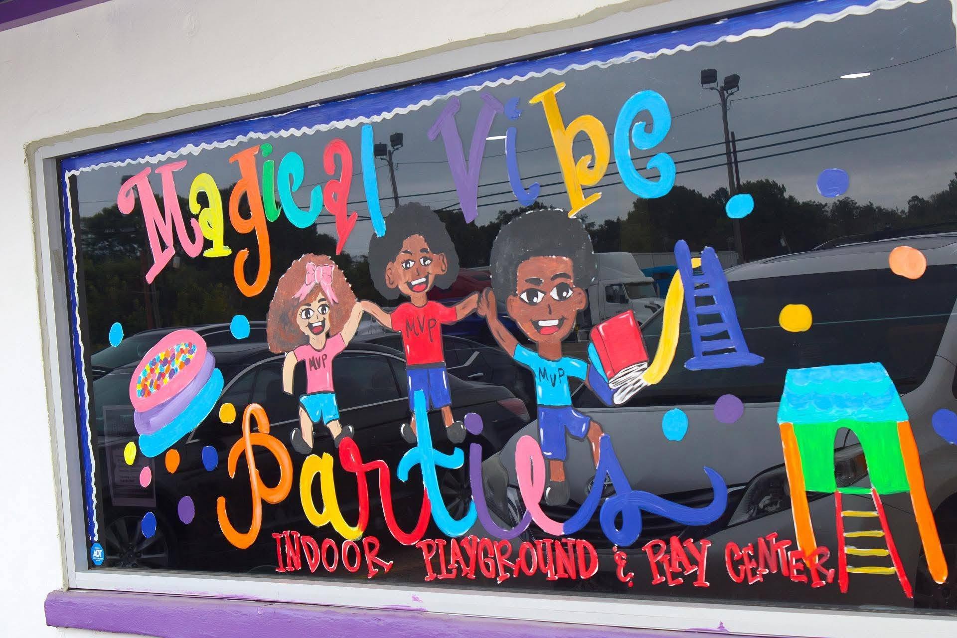 Colorful window display with children and text reading 'Magnet K-3 Part' and 'Indoor, Underground & Play Ground'.